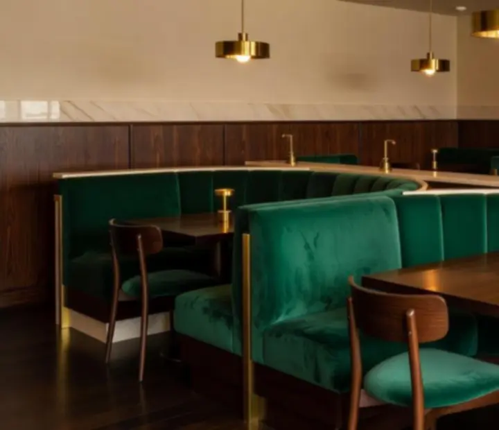 Emerald and gold interior of Wonderstar s. r. o. with velvet seating and warm lighting