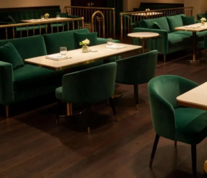 Emerald velvet lounge interior at Wonderstar s. r. o. with gold and marble details.